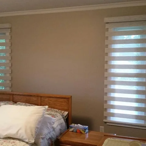 Banded roller shades installed on a bedroom window
