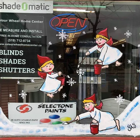 Store window offering blinds, shades and shutters with a winter mural