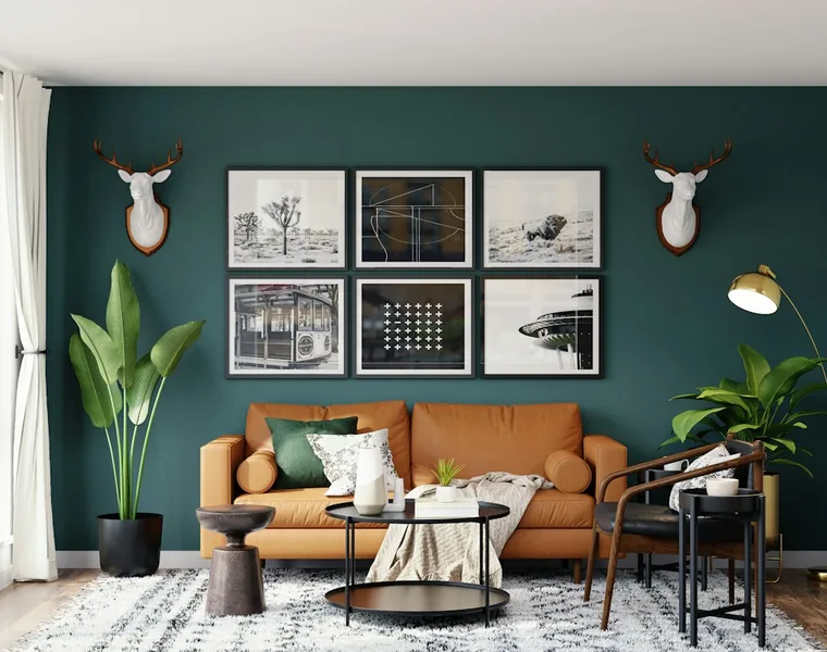 Living room with a dark green feature wall and tan leather sofa