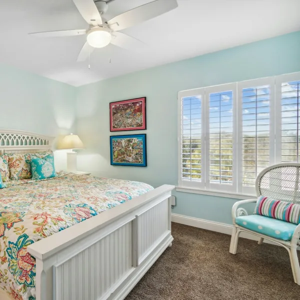 White plantation shutters in a bright bedroom